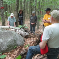 The group studies a glacial rock