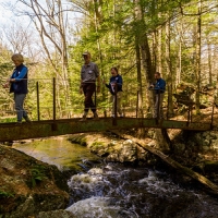Hikers crossing the I-beam bridge